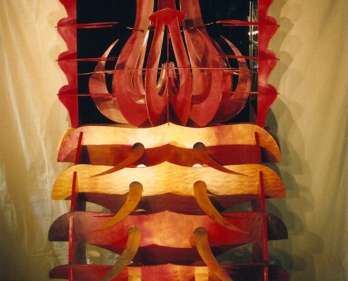 From Transforming Art by Chris Hardman, Reflected Symmetry is two mirrors set at 90 degrees with sculpted wooded, painted pieces placed between them.One-quarter of the image is real and three-quarters is not, only reflection.